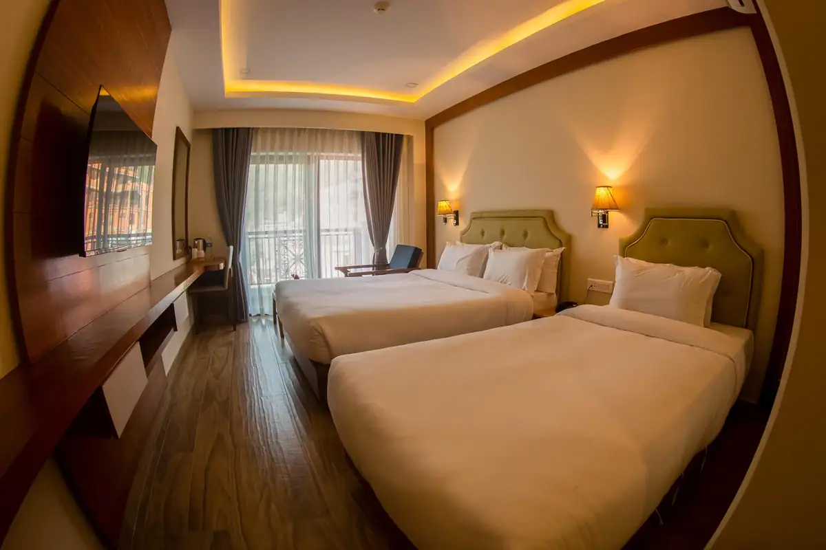 Family room with a double and single bed by the balcony